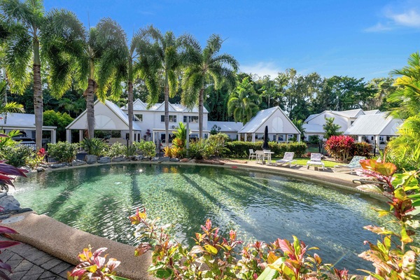 Cool off in the shared pool, a communal facility surrounded by tropical gardens that invites leisurely swims throughout the day.