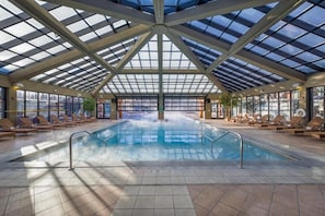 An indoor swimming pool with a glass ceiling, sun loungers, and a no diving sign. - Westgate Park City Resort & Spa (Park City)