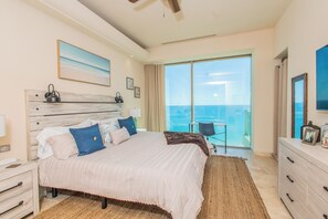 A bedroom with a bed, a desk, a chair, and a view of the sea. - Amazing Beachfront Condo, Tessoro at Las Conchas, Puerto Penasco (Las Conchas)