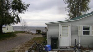 A house with a gravel driveway, a bicycle, and a mailbox.