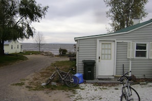 A house with a gravel driveway, a bicycle, and a mailbox.