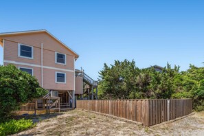 A two-story building with a wooden deck and a fenced backyard. - Only a 2 minute walk to the Avon beach! Private Pool, Hot Tub, Luggage Lift (Avon)