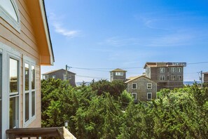 A residential area with multiple houses, a wooden deck, and dense greenery. - Only a 2 minute walk to the Avon beach! Private Pool, Hot Tub, Luggage Lift (Avon)