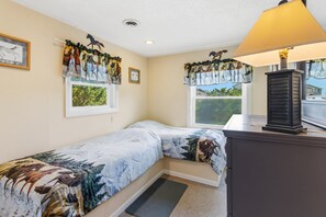 A bedroom with a bed, a dresser, a window with curtains, and a lamp. - Only a 2 minute walk to the Avon beach! Private Pool, Hot Tub, Luggage Lift (Avon)