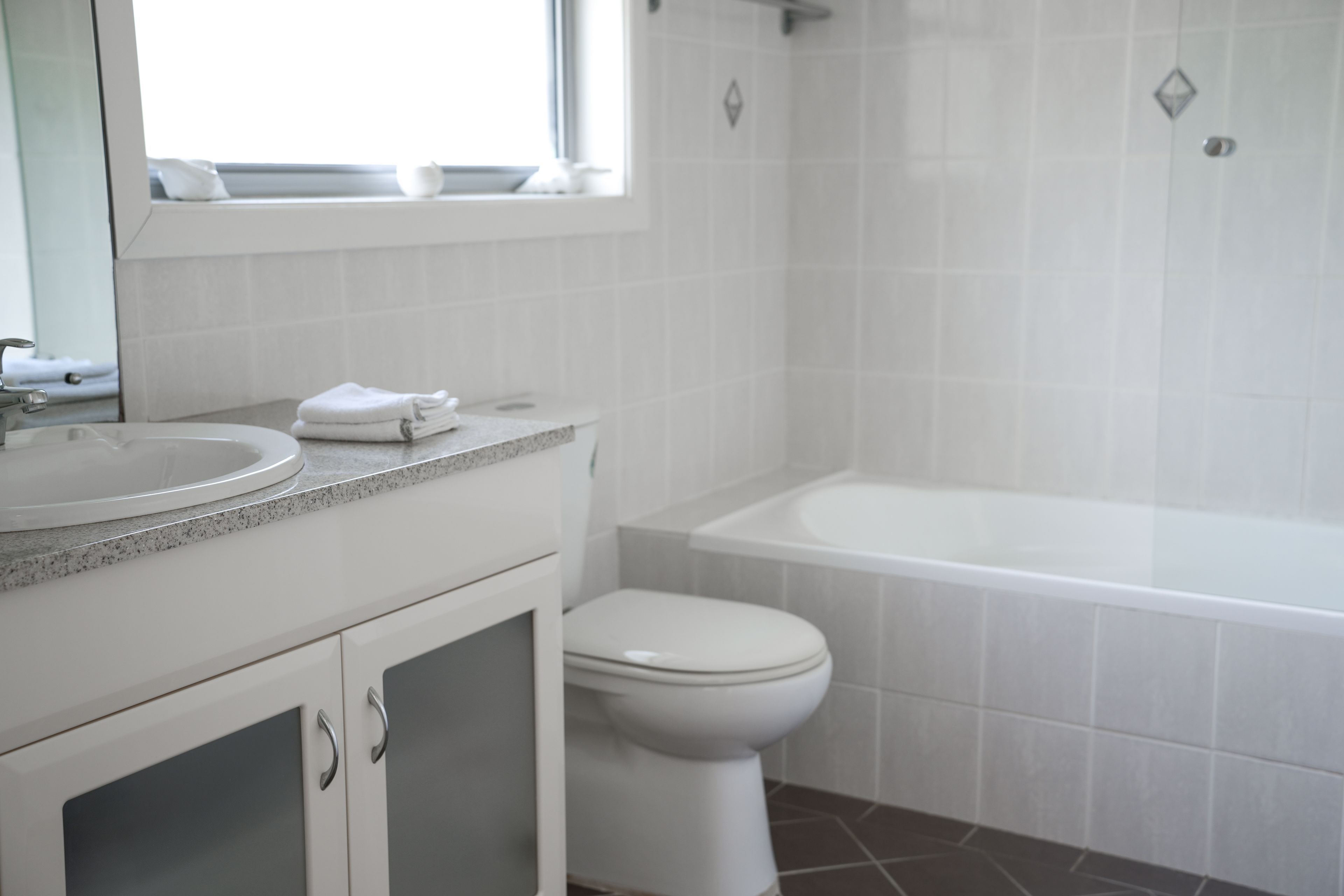 A bathroom with a sink, toilet, and bathtub.