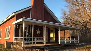 A red building with a white porch and a star emblem.