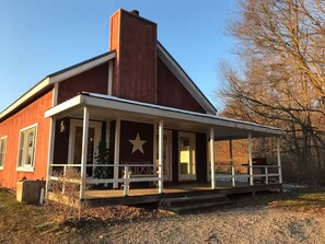 A red building with a white porch and a star emblem.