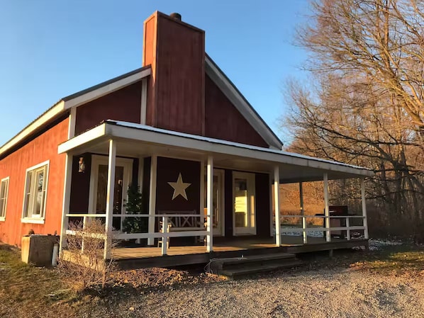 A red building with a white porch and a star emblem.