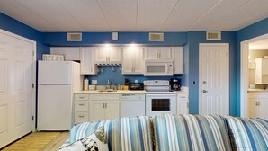 A compact kitchen with white cabinets, a refrigerator, a microwave, a toaster, and a coffee maker. - One Bedroom, Cozy, Beachside, Retreat, with Pool! (Brigantine)