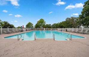 A rectangular pool with a tiled deck, surrounded by a white fence and trees. - Cozy 1-bedroom condo in lovely Branson (Branson)