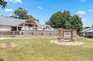 A building with a stone facade, a covered porch, and a sign for 'Holiday Hills Golf Club.' - Cozy 1-bedroom condo in lovely Branson (Branson)