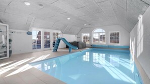 An indoor swimming pool with a slide, large windows, and a high ceiling. - VillaVilla 982 - Vedersø Klit, Vestjylland (Ulfborg)