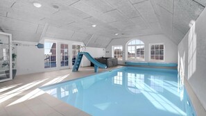An indoor swimming pool with a slide, large windows, and a high ceiling. - VillaVilla 982 - Vedersø Klit, Vestjylland (Ulfborg)