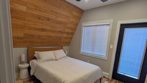 A bedroom with a bed, wooden ceiling, ceiling fan, and a window with blinds. - Charming 3-bedroom chalet in marvelous Livingston Manor with a majestic Stream (Livingston Manor)