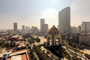 A cityscape with modern high-rise buildings, a prominent arch structure, and a clear sky. - w* | Enchanting Loft w/ Balcony in Tabacalera (Ciudad de México)
