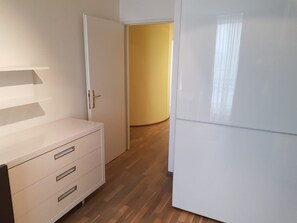A room with a white wardrobe, a white cabinet, and a white refrigerator. - Apartment Sleeps 6 with Garden & Balcony (Wien)