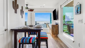 A dining area with a table, chairs, and a view of the city.