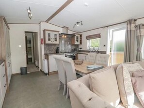 A compact living space with a kitchenette, a dining area, and a sofa.