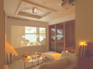 A modern living room with a sofa, coffee table, and a large window. - Esanghan Stay Suwon Ingye (Suwon)