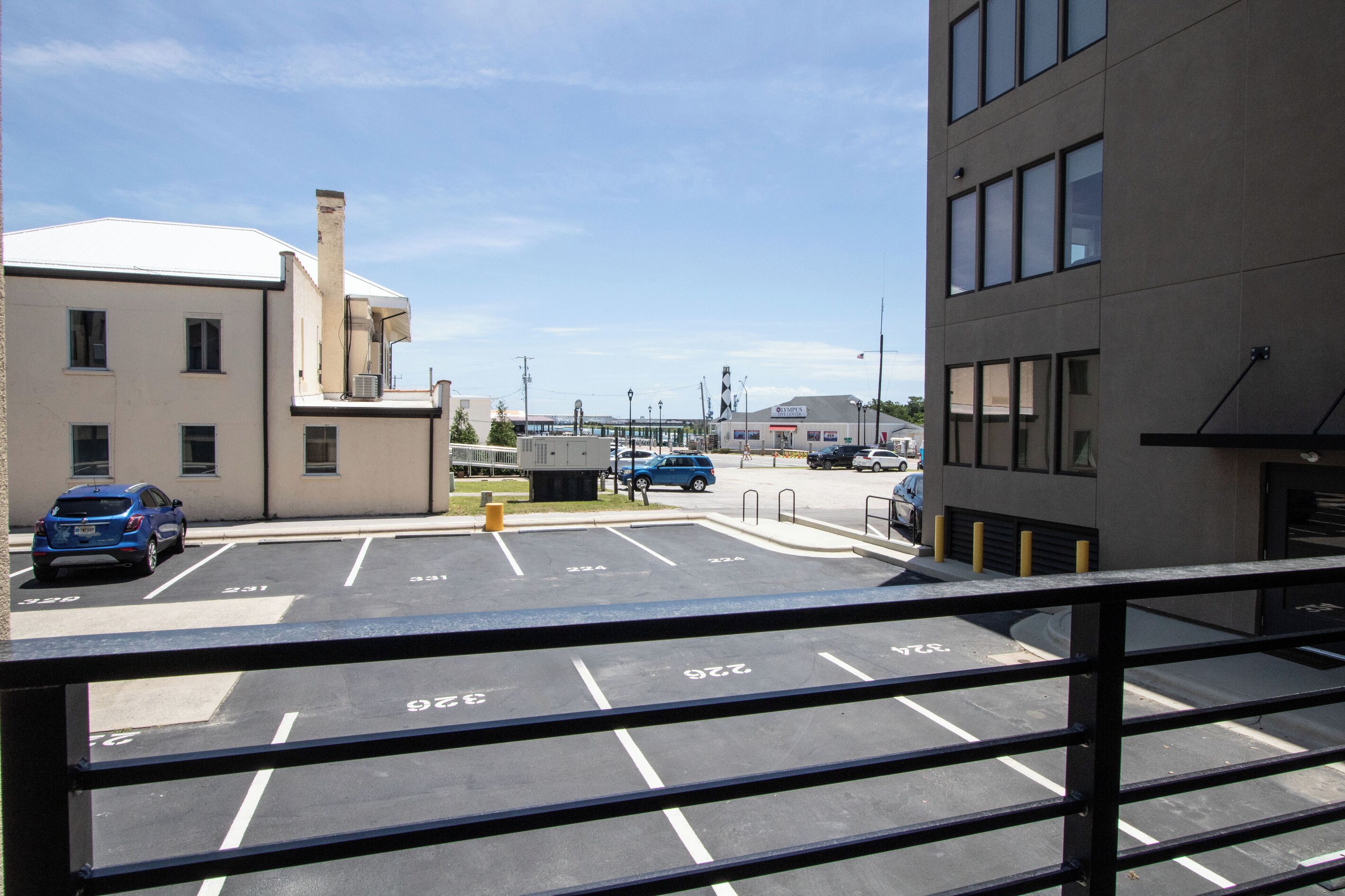 A parking lot with marked spaces and a building in the background.