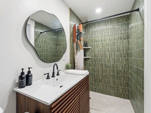 Een douche, handdoeken, zeep, toiletpapier