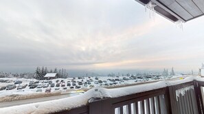 A snowy parking lot with cars and a building in the background. - Cozy 1 Bedroom Studio 249 Rimfire Lodge located in village with western sunset (Slaty Fork)