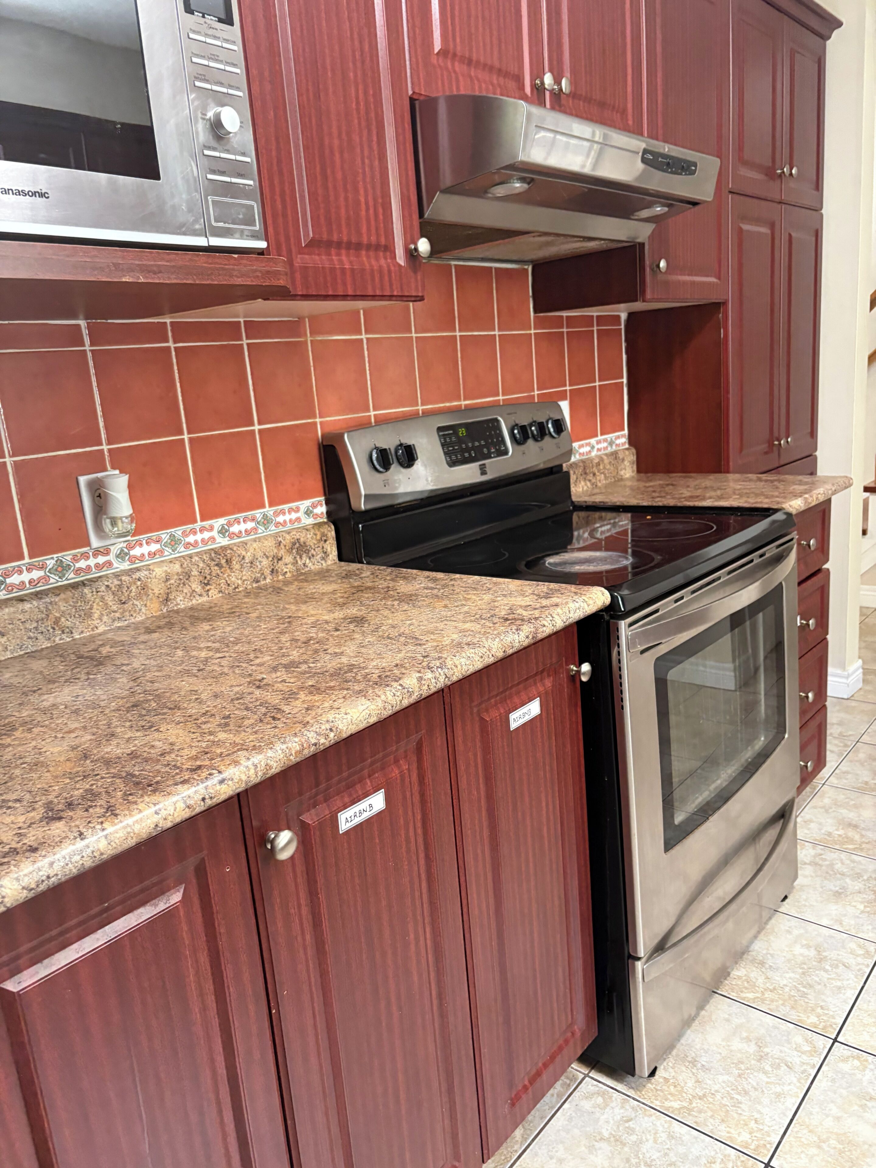 A kitchen with a stove, oven, and microwave.