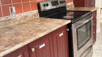 A kitchen with a stove, oven, and microwave.