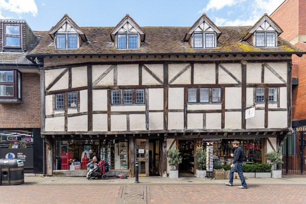 A traditional half-timbered building with a shop on the ground floor.