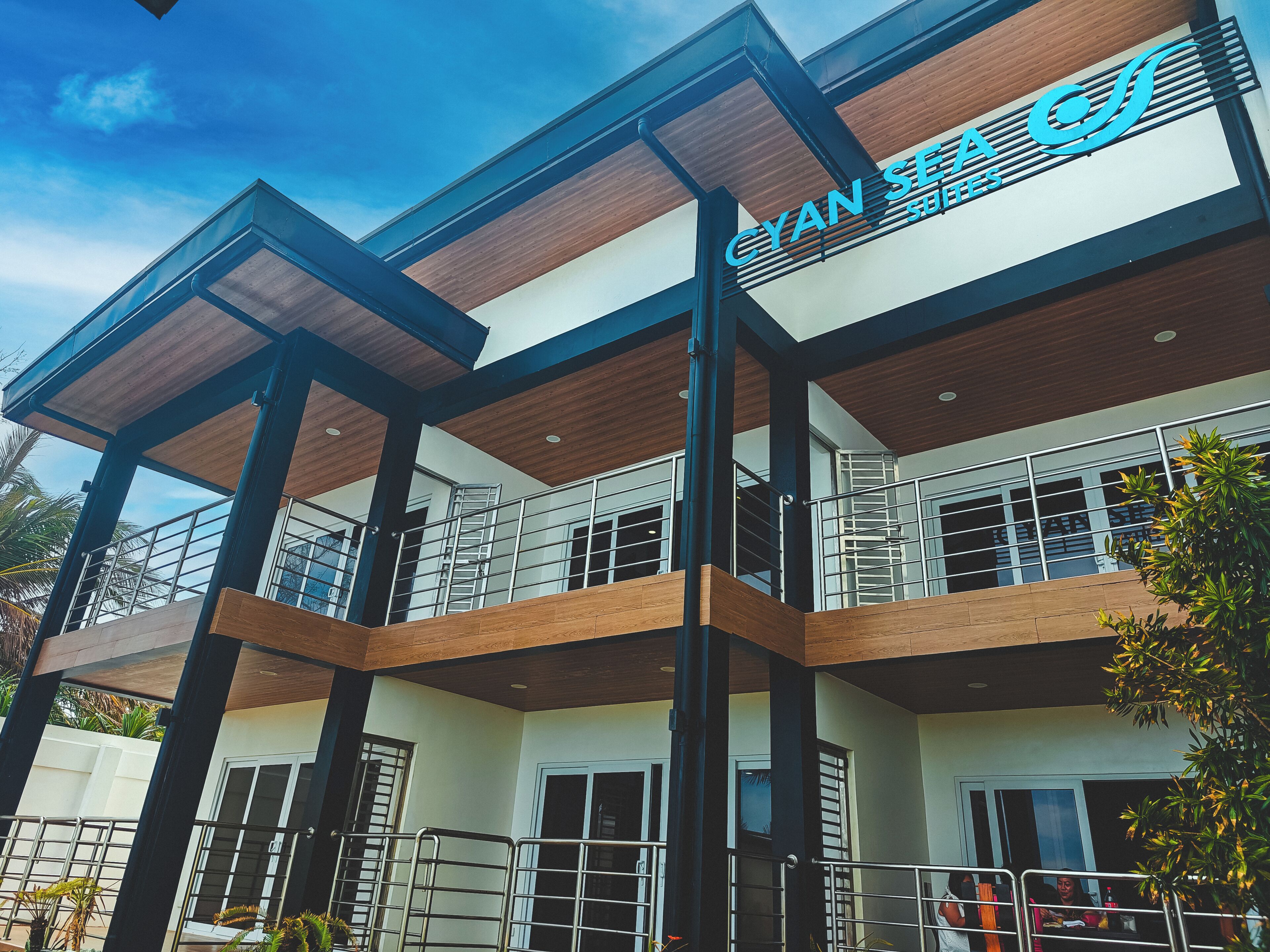 A multi-story building with a sign reading 'CYAN SEA SITES.'
