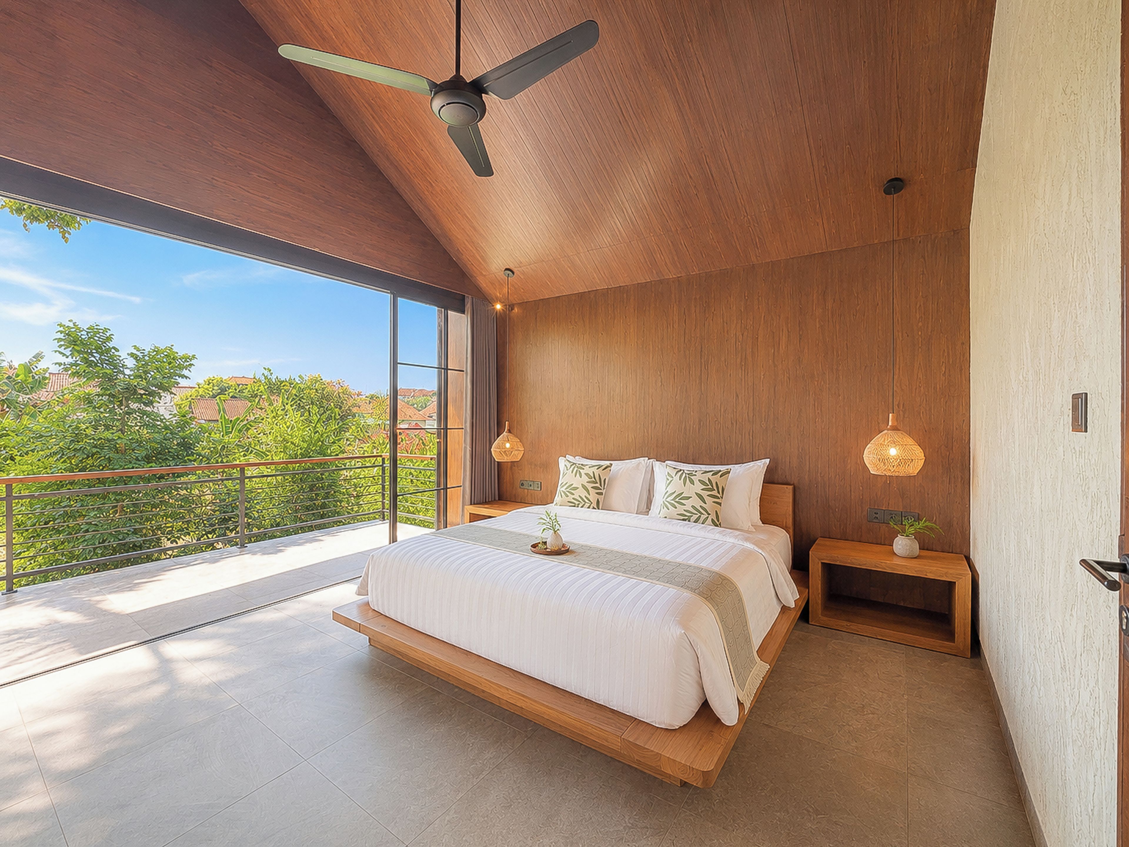 Un dormitorio moderno con una cama grande, techo de madera y vistas al exterior.
