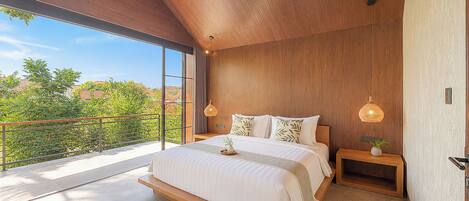 A modern bedroom with a large bed, wooden ceiling, and a view of greenery outside.