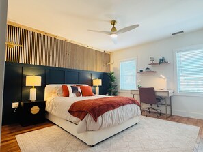 A bedroom with a bed, bedside tables, a desk, and a chair. - Fishtown 1 Bedroom + Detached Bonus bedroom, Private Outdoor Deck & Courtyard (Philadelphia)