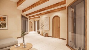 A modern interior with a wooden ceiling, a sofa, a coffee table, and a glass door.