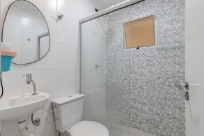 A bathroom with a sink, toilet, and a shower with a glass door. - Studio 07 com Wi-fi e Pr Ximo ao Shopping Tatuap (São Paulo)