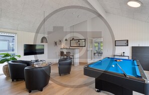 A modern living room with a pool table, comfortable seating, a flat-screen TV, and a dining area. - Gorgeous home in Rødby with sauna (Rødby)