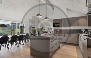 A modern kitchen with a central island, pendant lighting, and a view of greenery outside. - Gorgeous home in Rødby with sauna (Rødby)