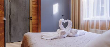 A hotel room with a bed, a wardrobe, and a window.