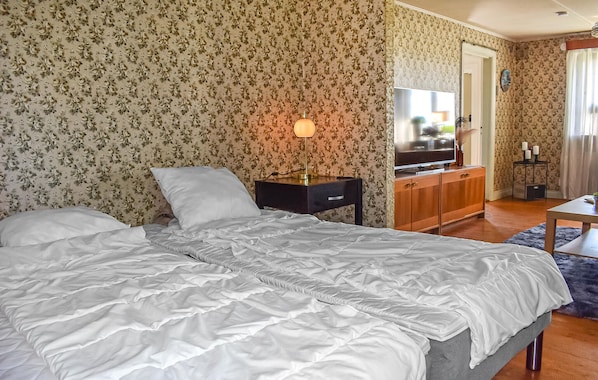 A bedroom with a bed, a nightstand, a dresser, a mirror, and a television. - Awesome home in Ystad with WiFi (Ystad)