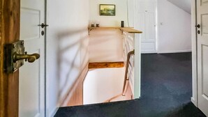 A hallway with a door leading to a room with a bed and a small table. - 2 bedroom lovely home in Lönashult (Lönashult)