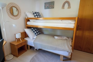 A bunk bed room with a bedside table, lamp, and a small rug. - Via Radiras - Laax | Flims | Lake Cauma | Hiking (Laax)