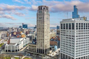 A cityscape with a prominent tall building, a shorter building labeled 'David Whitney Building,' and a modern skyscraper in the background. - Urban Loft Living in Downtown Detroit & Gym (Detroit)