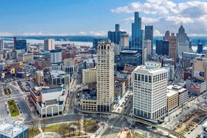 A cityscape with various buildings, roads, and a river. - Urban Loft Living in Downtown Detroit & Gym (Detroit)