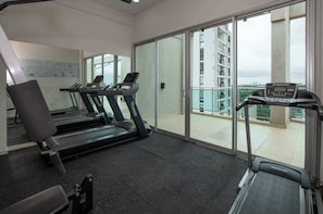 Ein Fitnessraum mit Laufbändern, einem Ergometer und einem Rudergerät.