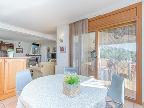 A dining area with a round table, chairs, and a decorative centerpiece. - Mestral by Interhome (Palau Savardera)