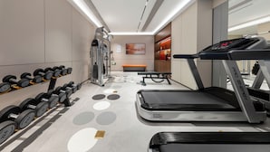 A gym with treadmills, dumbbells, and a weight machine. - UrCove Yangzhou China Grand Canal Museum (Yangzhou)