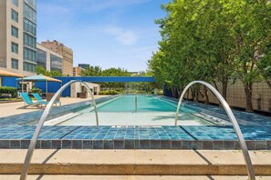 A swimming pool with a no diving sign, lounge chairs, and a covered seating area. - Luxury Downtown Dallas Retreat with King Bed, Pool and Hot Tub (Dallas)
