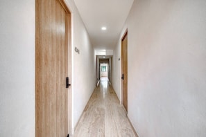 A hallway with wooden doors, a tiled floor, and a ceiling with recessed lighting. - Casa Myla - 1BR in Roma Norte - HighF (Mexico City)