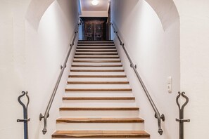 A staircase with wooden steps and metal handrails, leading to a dark wooden door at the top. - Chalet in Piesendorf near Kaprun near skiresort (Angerberg)