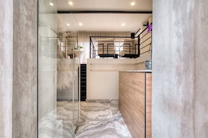 A modern interior with a glass partition, a staircase, and a wooden counter. - Myla 02R - 1BR Near Reforma - HighF (Mexico City)